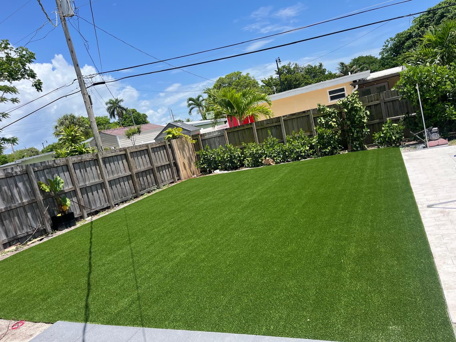 Artificial turf installation for residential backyard in Broward County, South Florida